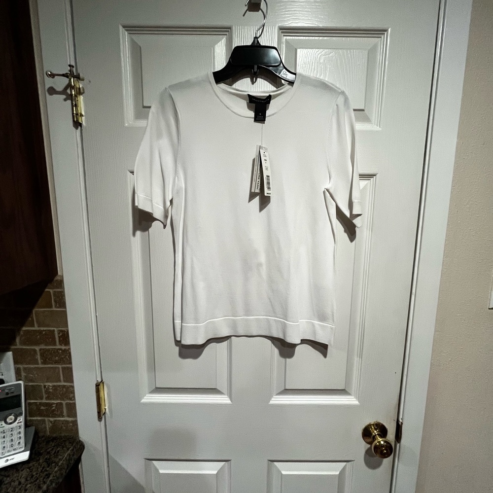 Small white Investment pull over top. New with tags. Never worn.